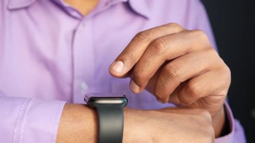 Hand Interacting with Smart Watch Close Up