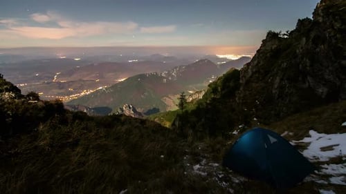 Camping Tent Overlooking City at Night