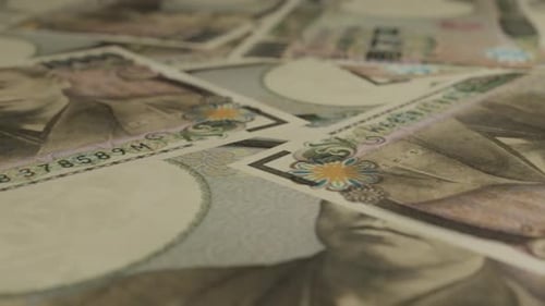 Japanese Yen Banknotes Close-up Panning Across Scattered Currency