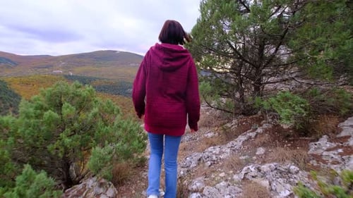 Woman Hiking on a Hill with Scenic View
