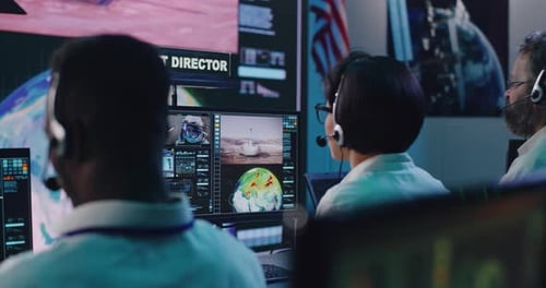 Team Monitors Space Mission From Control Room