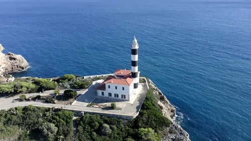Portocolom lighthouse on cliff at the sea, Mallorca, Spain