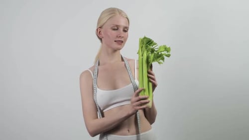 Close Up of Smiling Woman Eat Celery on White Background