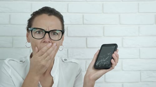 Woman Shocked by Broken Mobile Phone Screen