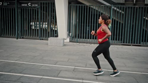 Woman Running for Exercise in Urban Setting