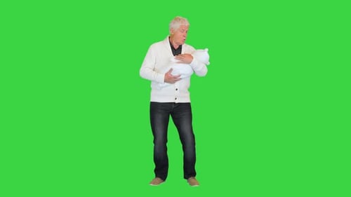 Grandfather Standing and Holding Grandson on a Green Screen Chroma Key