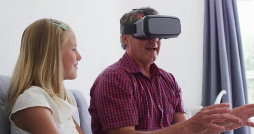Grandfather Experiences VR with Granddaughter at Home