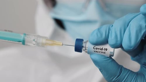 Healthcare Worker Draws Covid-19 Vaccine into Syringe