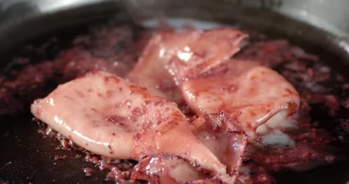Close Up of Steaming Squid Cooking in Pan