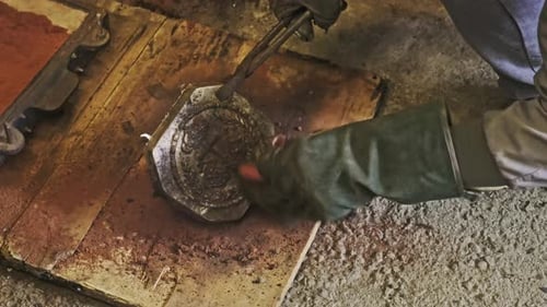 Artisan working with metal casting