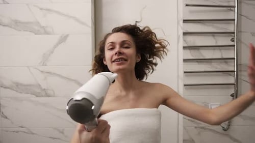 Smiling Woman Dries Hair with Hair Dryer