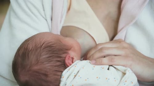 Mujer padre alimenta a un niño recién nacido de cinco días de edad leche su pecho
