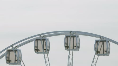 Ferris Wheel Rotating Against Cloudy Sky
