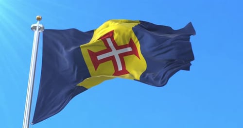 Madeira Flag Waving in Wind Against Blue Sky