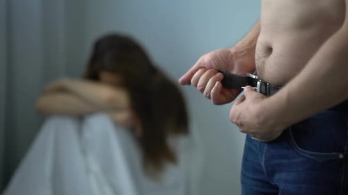 Distressed Woman with Man and Belt