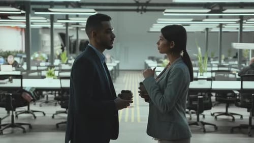Young Diverse Man and Woman Colleagues Talking Together During Coffee Break Laughing at Office Zoom