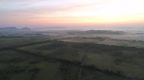 Aerial View of Foggy Rural Landscape at Sunrise