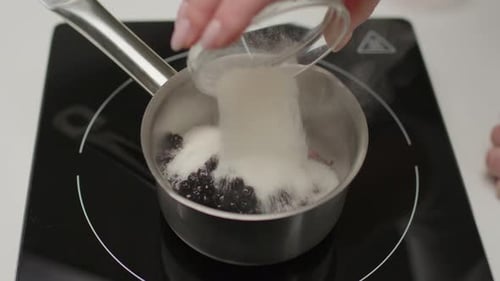 Berries and Sugar Simmering on Cooktop Close Up
