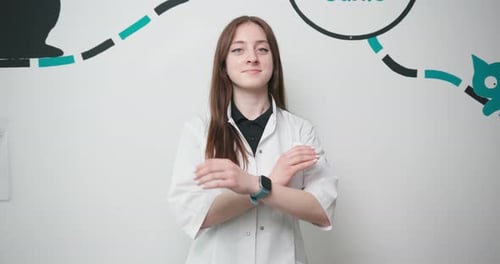 Young Woman Doctor Veterinarian with Arms Crossed Looking at Camera