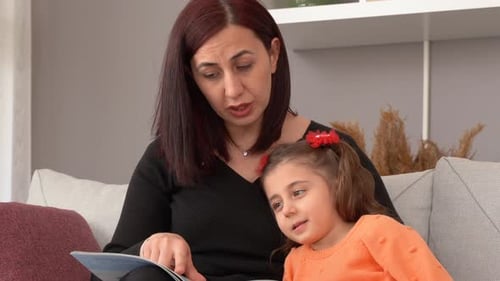 Mother and Child Reading a Book Together at Home