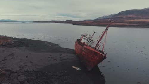 Rusty ship near river coast