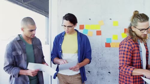 Four Young Adults Meeting in an Office