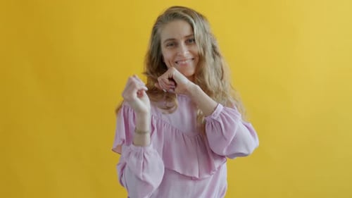 Woman Dances in Front of Yellow Background