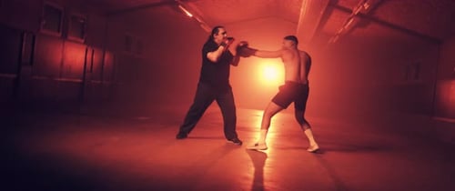 Two Men Boxing at Night in Urban Setting