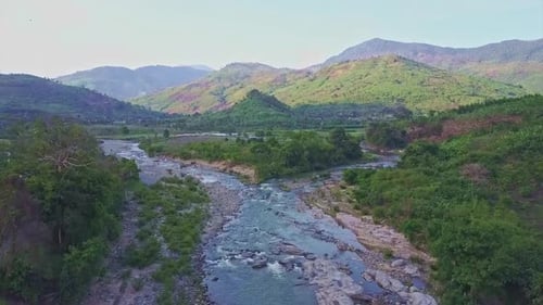 Drone Flies Over River Near Road Against Tropical Lands