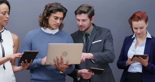 Group of executives using laptop and digital tablet
