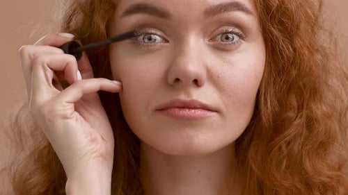 Woman Applies Mascara in a Close Up Shot