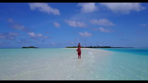 Teenage lovers tanning on tropical tourist beach wildlife by blue water and white sandy background o