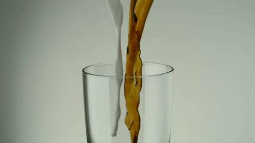 Brown and White Liquid Pouring into Glass
