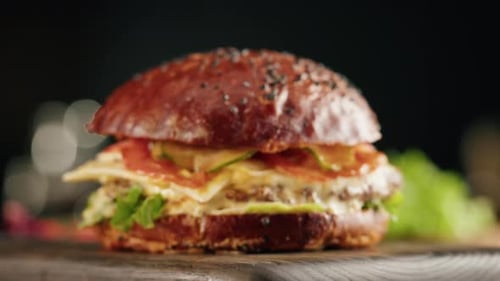 Close Up of Cheeseburger on Wooden Platter