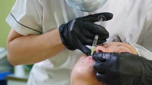Medical Professional Injects Lips with Filler, Close Up