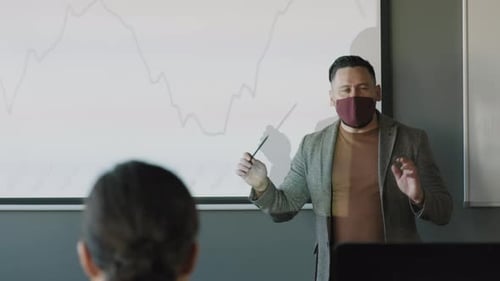 Man Giving Business Presentation Wearing Face Mask
