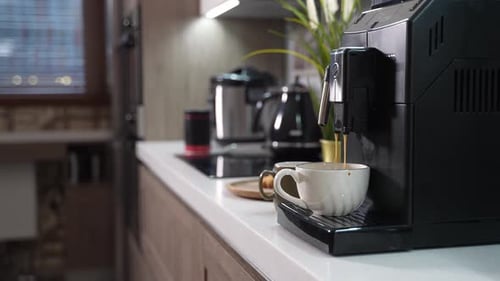 Coffee Pouring into Cup From Espresso Machine