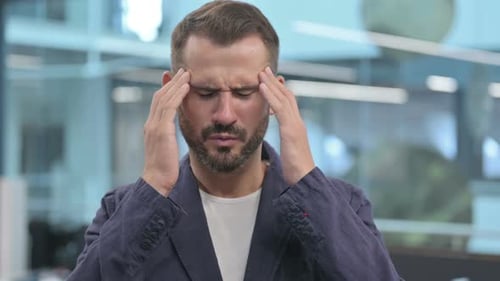 Man Rubs Temples Due to Stress