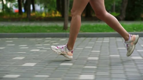 Closeup of Female Athlete's Feet Running at the Park