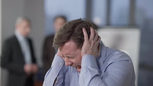 Closeup Portrait of Angry Furious Caucasian Man Screaming in Office Indoors