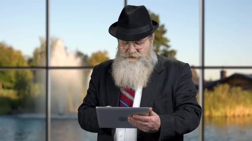 Senior Scrolls on Tablet Device