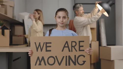 Family Moving to New Home With Cardboard Boxes