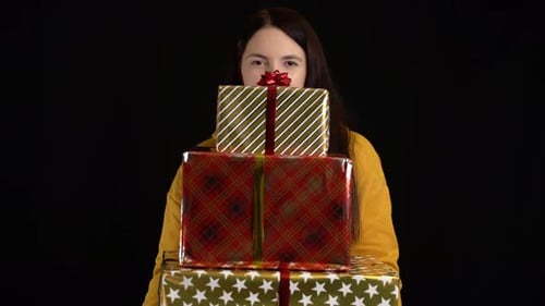 Woman Holding Stack of Christmas Holiday Presents