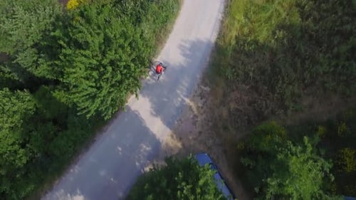 Man cycling with mountain bike on countryside road
