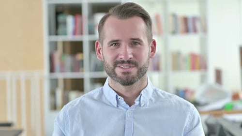 Young Adult Man Waving and Talking to Camera