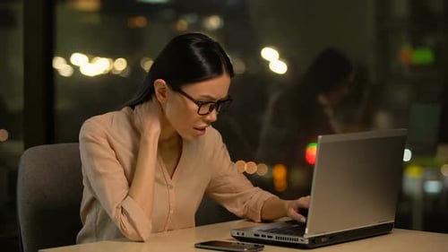 Tired Woman Working Late on Laptop