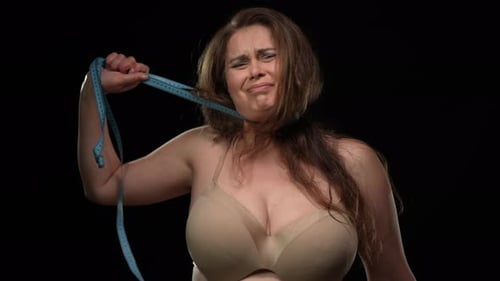 Distraught Woman with Measuring Tape on Black