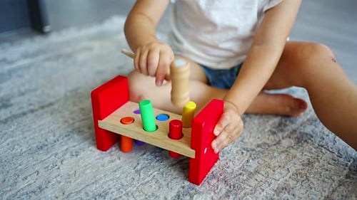 Cute Caucasian Little Girl Playing on the Floor at Home with Eco Wooden Toys
