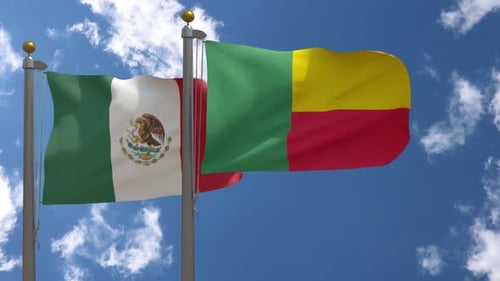 Mexico and Benin Flags Waving in Wind Against Blue Sky
