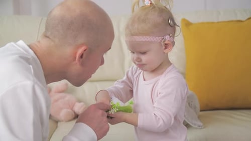 Little Girl with Hearing Aid Playing with Family